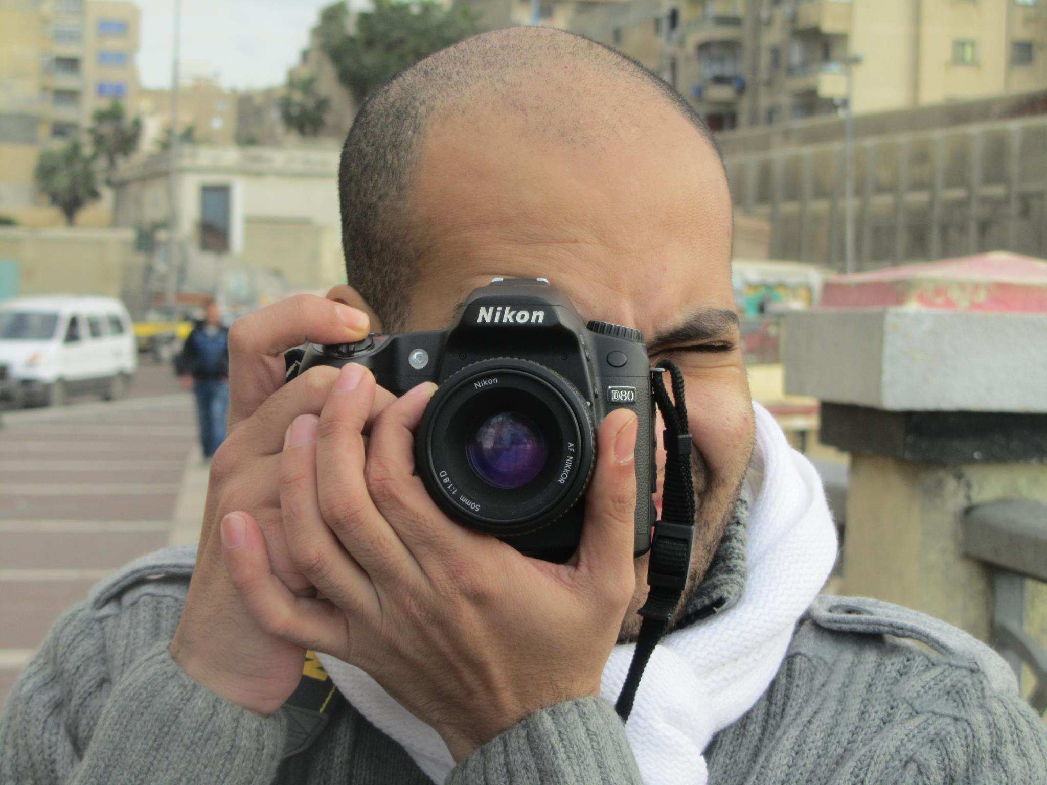 Ahmed looking through his Nikon camera